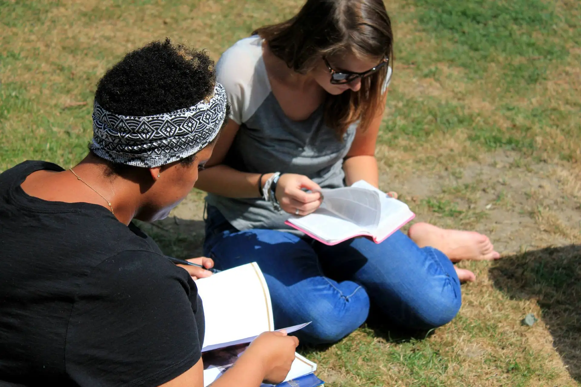 Two people studying the Bible together outdoors