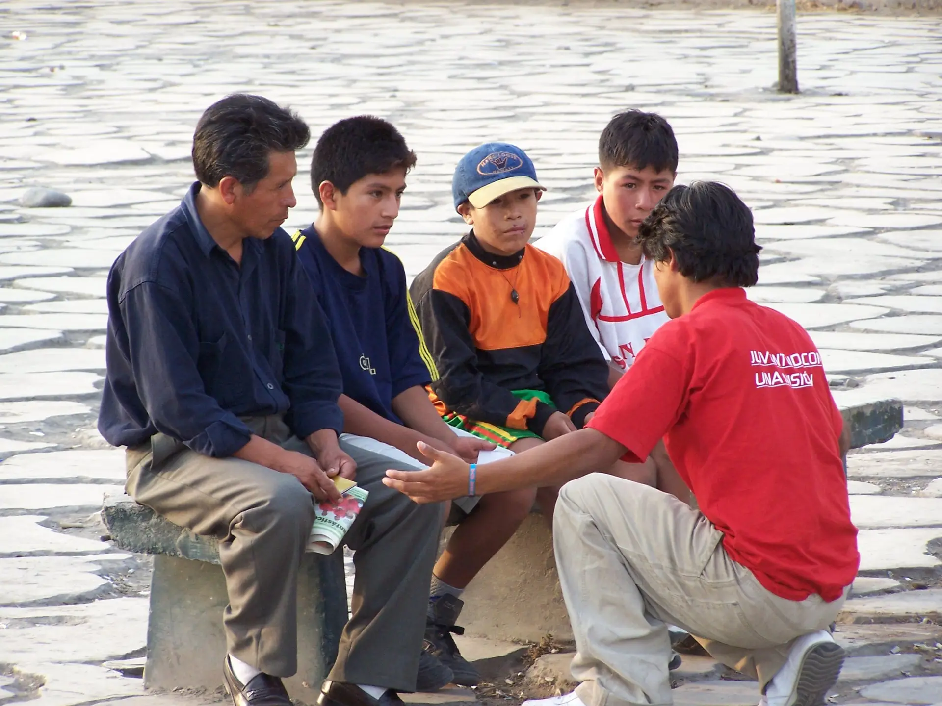 Small group sharing a conversation during outreach in Peru